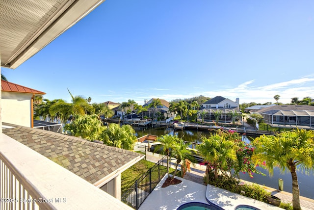 balcony featuring a water view and a jacuzzi