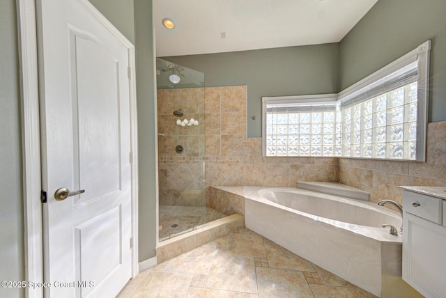 bathroom featuring tile patterned flooring, vanity, separate shower and tub, and tile walls