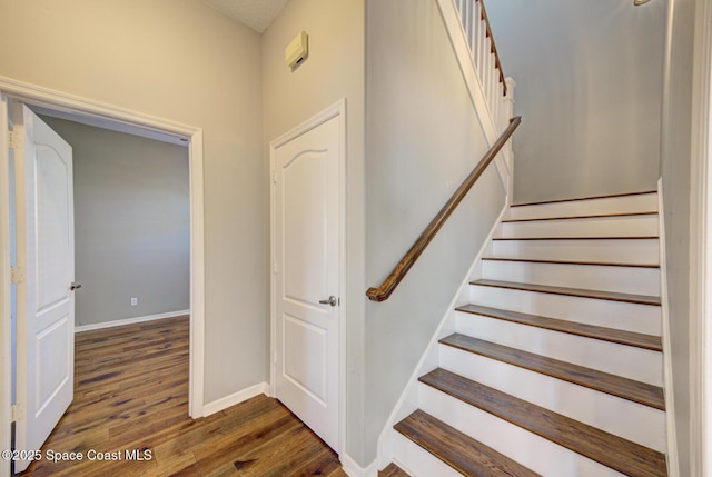 stairs with wood-type flooring