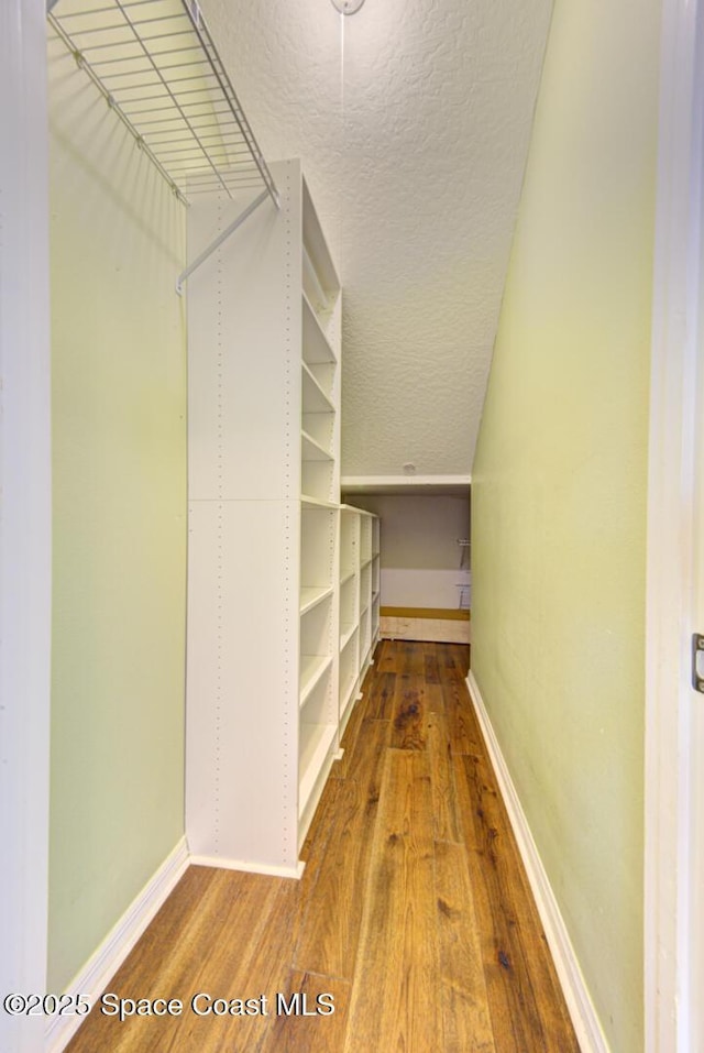 spacious closet featuring hardwood / wood-style floors