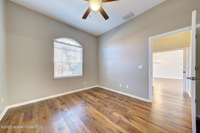 spare room with ceiling fan and dark wood-type flooring