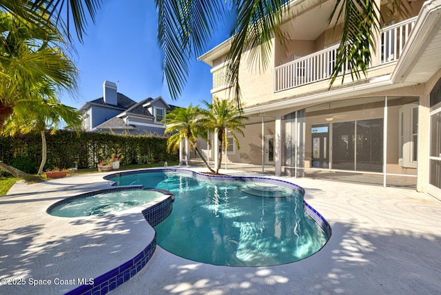 view of pool featuring a patio area and an in ground hot tub