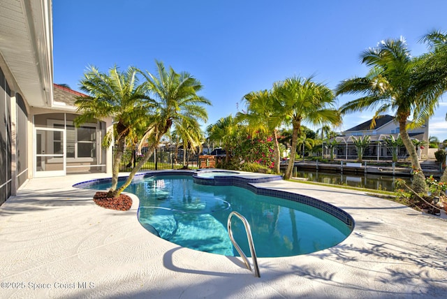 view of pool featuring a patio area and a water view