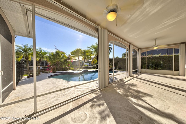 view of swimming pool with ceiling fan and a patio area