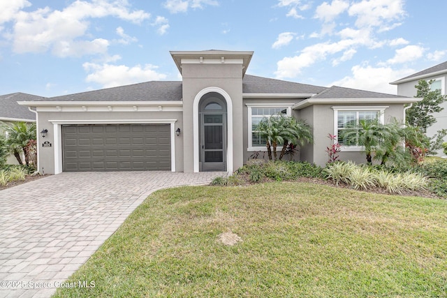 view of front of house featuring a front yard and a garage