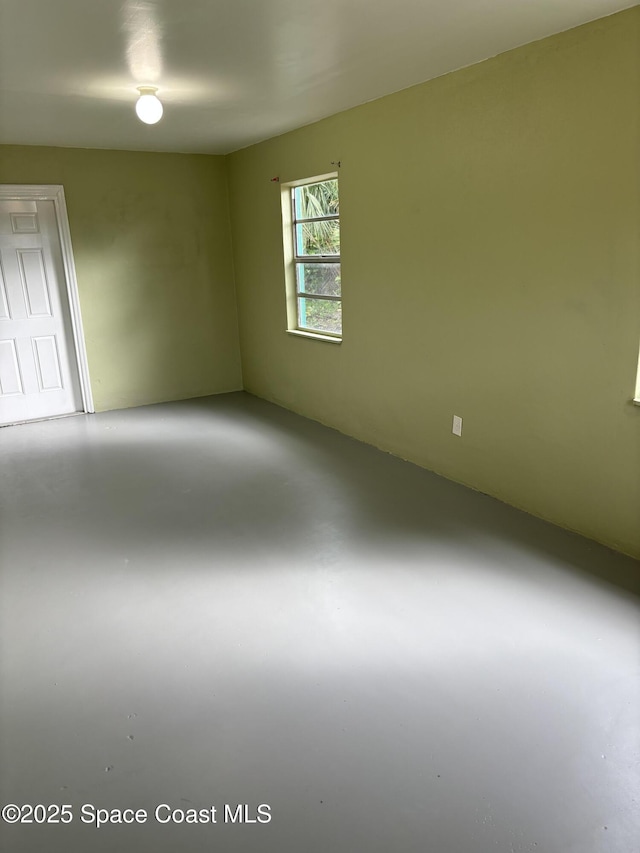 empty room with concrete flooring