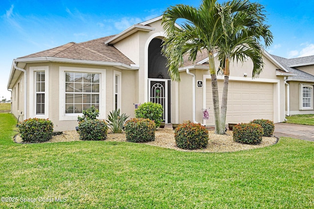 view of front of property with a garage and a front yard