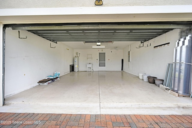 garage featuring electric panel and electric water heater