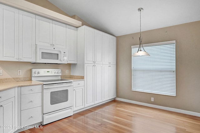 kitchen with pendant lighting, white appliances, lofted ceiling, and white cabinets