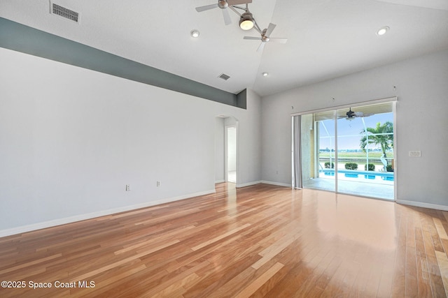 empty room with high vaulted ceiling, ceiling fan, and light wood-type flooring