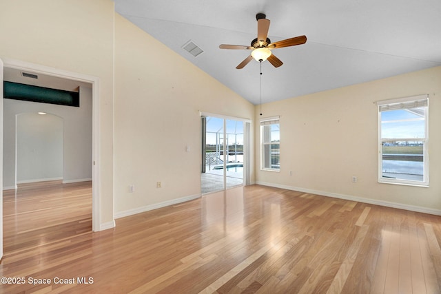 spare room with ceiling fan, light wood-type flooring, and a wealth of natural light