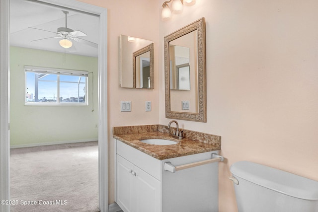 bathroom featuring ceiling fan, vanity, and toilet