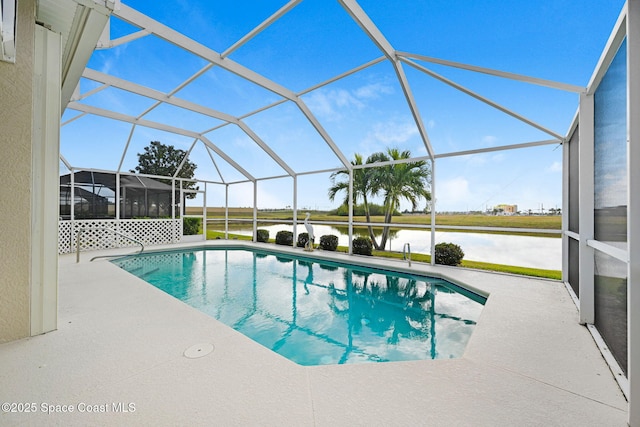 view of pool with a patio, a water view, and glass enclosure