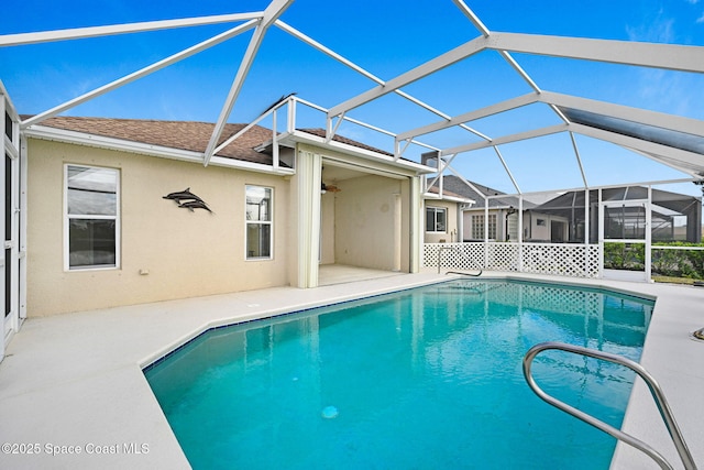 view of swimming pool with a lanai and a patio