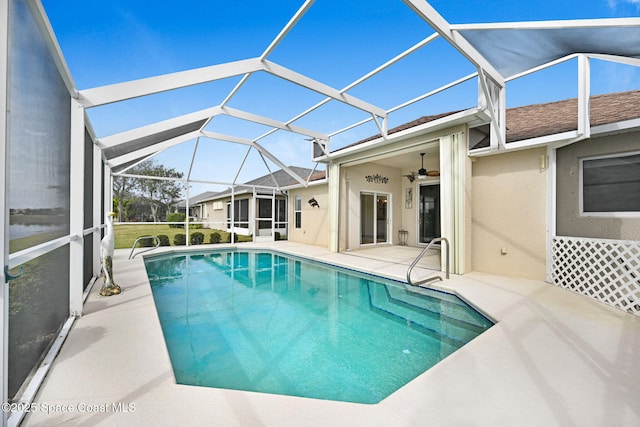 view of pool featuring ceiling fan, a lanai, and a patio