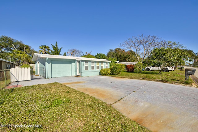 ranch-style home with a garage and a front lawn