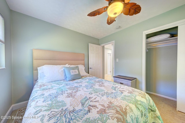 tiled bedroom featuring ceiling fan and a closet