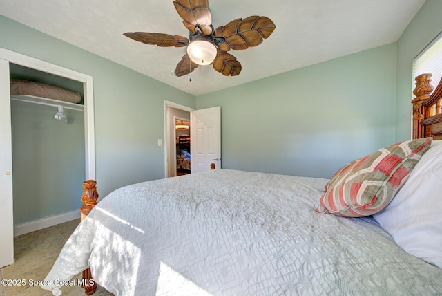 bedroom featuring ceiling fan, light tile patterned flooring, and a closet