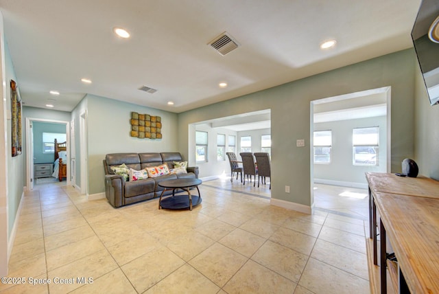 living room featuring light tile patterned flooring and a wealth of natural light