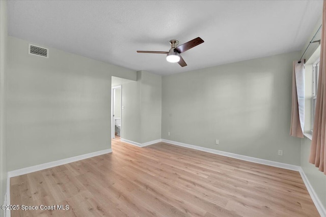 unfurnished room with ceiling fan, light hardwood / wood-style floors, and a textured ceiling