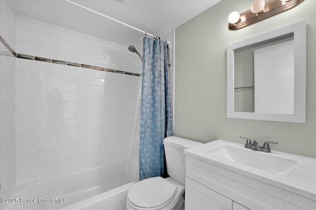 full bathroom featuring shower / bath combo with shower curtain, vanity, and toilet