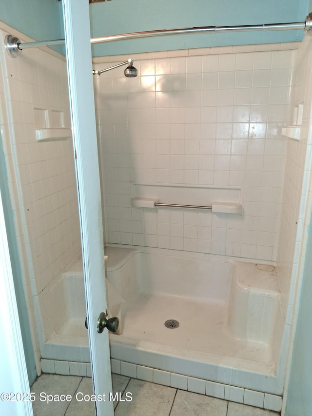 bathroom with tile patterned flooring and walk in shower