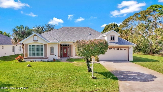 view of front of property with a front yard and a garage