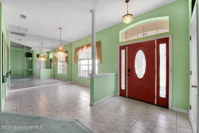 foyer featuring light tile patterned floors and a chandelier