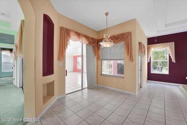 unfurnished dining area with a notable chandelier and light tile patterned floors