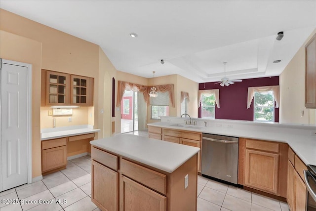 kitchen featuring ceiling fan with notable chandelier, a tray ceiling, sink, light tile patterned floors, and dishwasher