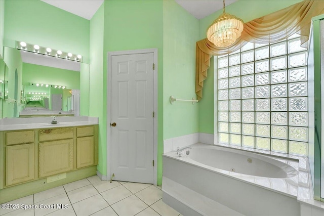 bathroom featuring tile patterned floors, a bath, a healthy amount of sunlight, and an inviting chandelier