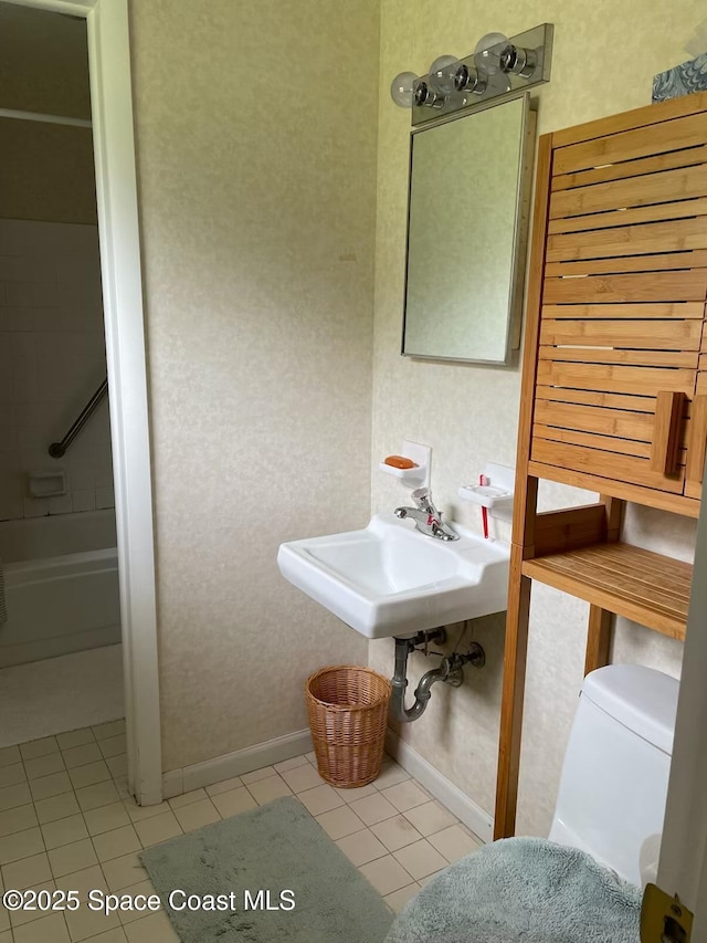 full bathroom with shower / tub combination, sink, tile patterned floors, and toilet