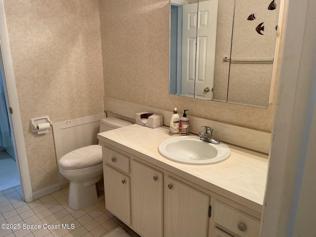 bathroom with vanity, tile patterned floors, and toilet