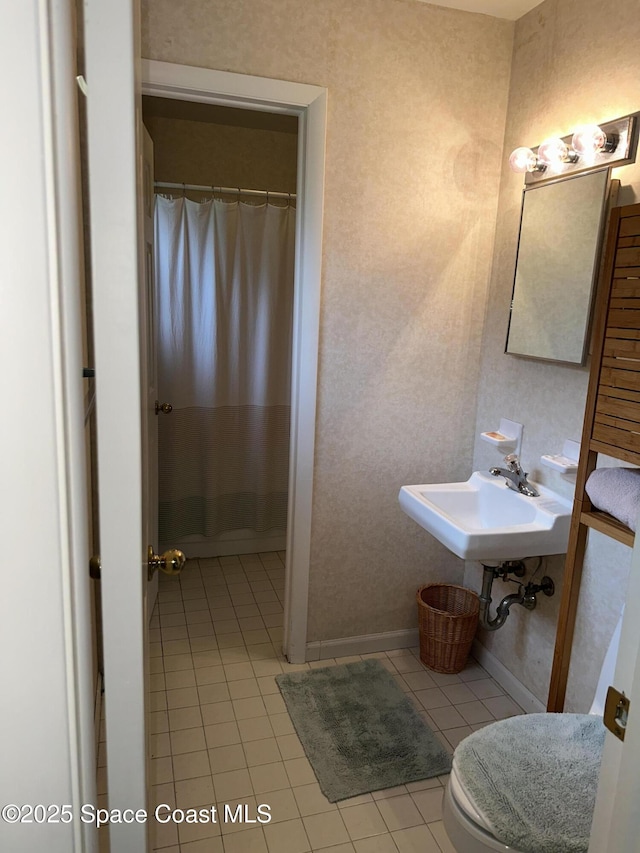 bathroom featuring sink, tile patterned floors, toilet, and a shower with shower curtain