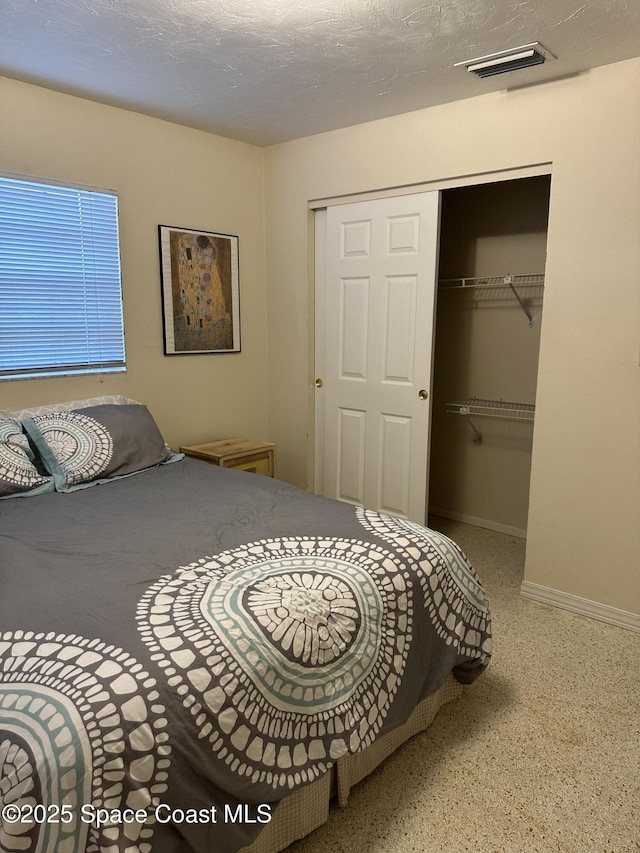 bedroom featuring a closet and a textured ceiling