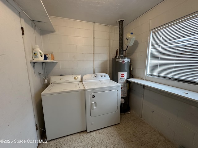 clothes washing area with water heater and washer and dryer