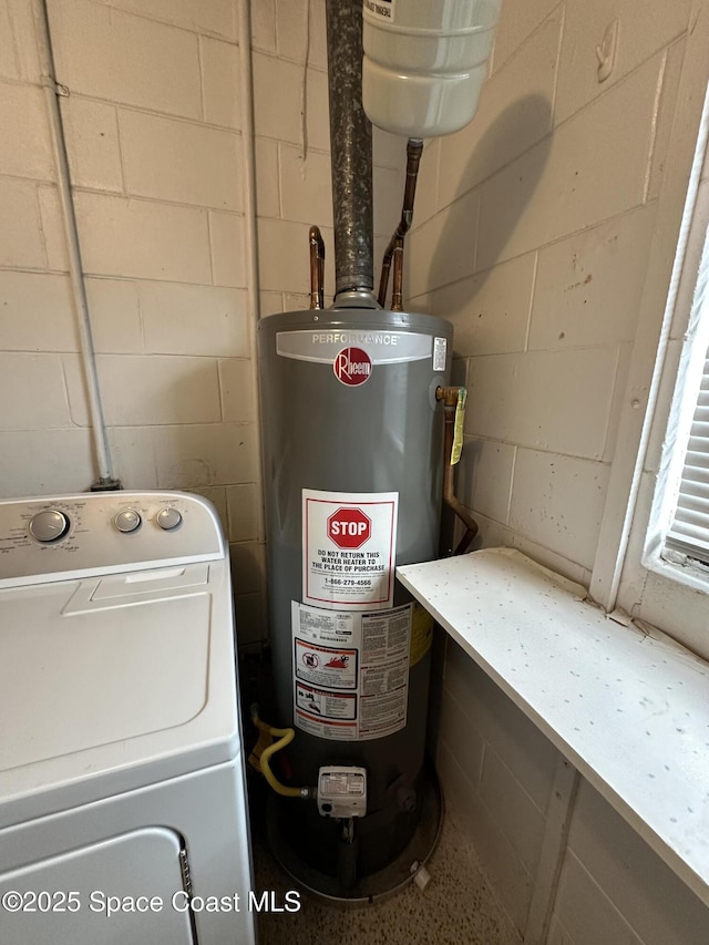 interior space with washer / clothes dryer and gas water heater