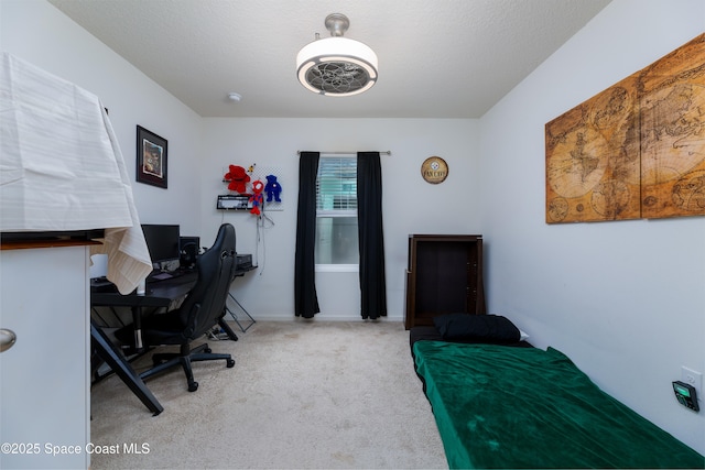 carpeted office featuring a textured ceiling