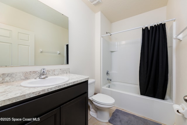 full bathroom with shower / bath combo, tile patterned flooring, a textured ceiling, toilet, and vanity