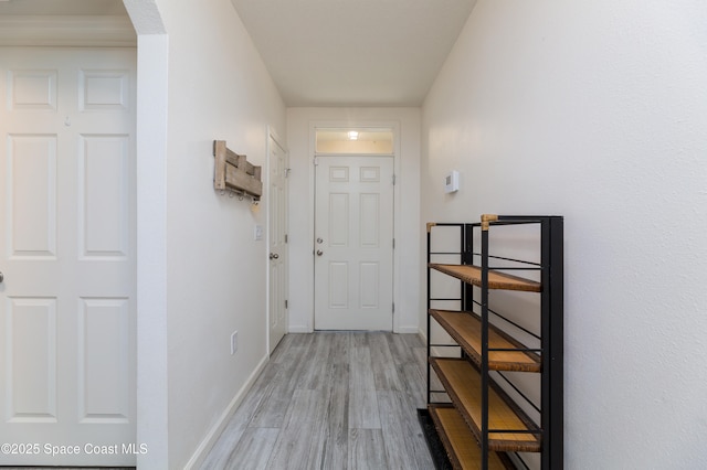 hallway with hardwood / wood-style flooring