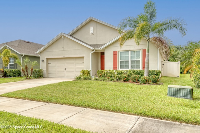 view of front of property with a front yard and a garage