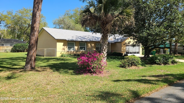 ranch-style home featuring a front yard