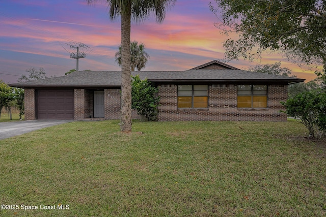 view of front of property featuring a lawn and a garage