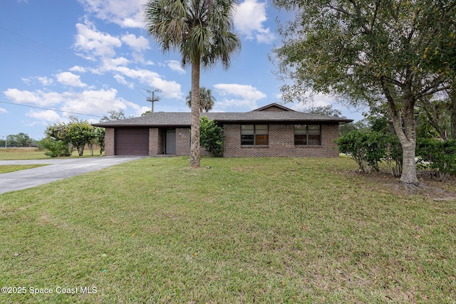 ranch-style home with a garage and a front lawn