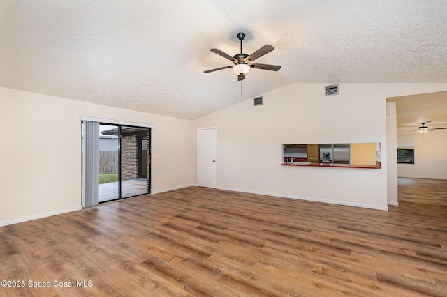 unfurnished living room with hardwood / wood-style floors, ceiling fan, and lofted ceiling