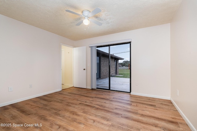 empty room with wood-type flooring, a textured ceiling, and ceiling fan