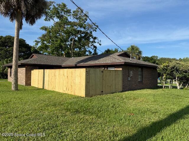 901 Emerson Dr NE, Palm Bay, FL 32907 - view of side of property with a lawn