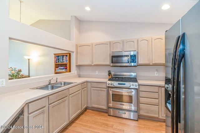 kitchen with sink, light brown cabinets, light wood-type flooring, and appliances with stainless steel finishes