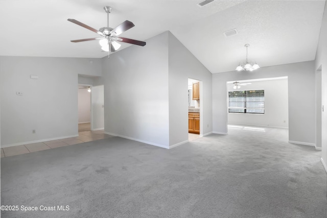 unfurnished living room featuring ceiling fan with notable chandelier, light colored carpet, and high vaulted ceiling