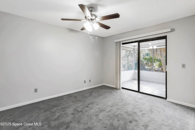 spare room featuring ceiling fan, a textured ceiling, and carpet flooring